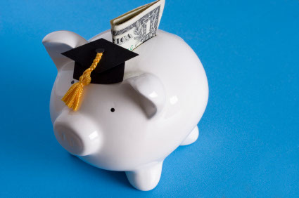Piggy bank with a graduation cap with dollar bill