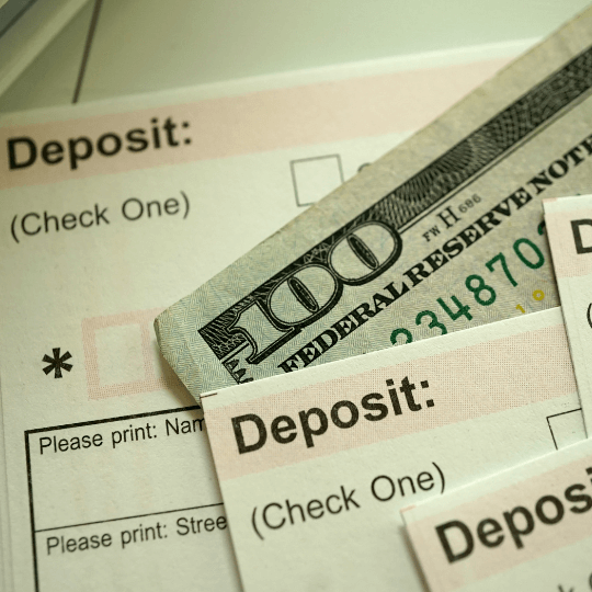 Close-up of deposit slips and a hundred-dollar bill representing estate fund disputes in Texas.