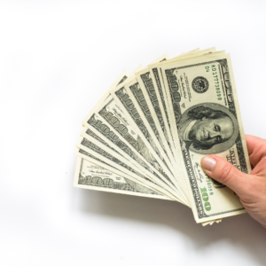 Hand holding a fan of $100 bills, illustrating an inheritance that may be disclaimed